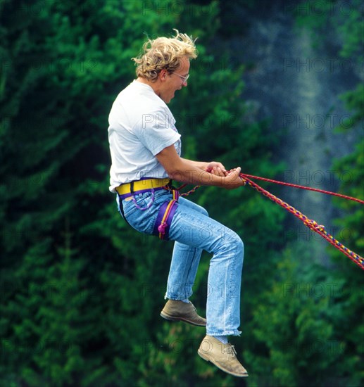 Man, about 24 years old, jumping on a climbing rope secured by the bridge, Echelsbacher Bridge, Bavaria, Germany, retro, vintage, old, retro, vintage, old, Europe