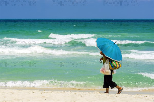 Woman on the beach with parasol as sun protection, ozone, heat, protection, light protection, local, travel, travel photo, holiday, symbol, symbolic, sea, beach, clothes, summer, sun, summer holiday, Koh Samui, Thailand, Asia