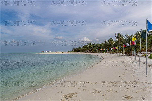 White sand beach with many flags, Bangaram island, Lakshadweep archipelago, Union territory of India