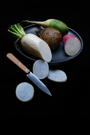 Various radishes on a plate, sliced, Raphanus