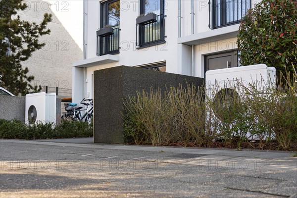 Two heat pumps in the front garden of terraced houses in Duesseldorf, North Rhine-Westphalia, Germany, Europe