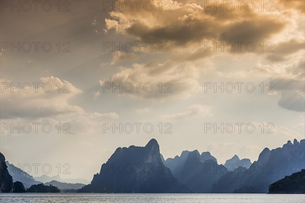 Limestone rocks in the evening light in Cheow Lan Lake in Khao Sok National Park, evening, sunset, light mood, nature, travel, holiday, lake, reservoir, landscape, rock, rock formation, attraction, water, tourism, boat trip, excursion, landscape, natural landscape, boat trip, nature reserve, travel photo, Thailand, Asia