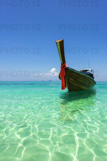 Longtail boat, fishing boat, wooden boat, decorated, tradition, traditional, faith, cloth, colourful, bay, sea, ocean, Andaman Sea, tropical, tropical, island, water, beach, beach holiday, Caribbean, environment, clear, clear, clean, peaceful, picturesque, sea level, climate, travel, tourism, paradisiacal, beach holiday, sun, sunny, holiday, dream trip, holiday paradise, paradise, coastal landscape, nature, idyllic, turquoise, Siam, exotic, travel photo, sandy beach, seascape, Phi Phi Island, Thailand, Asia