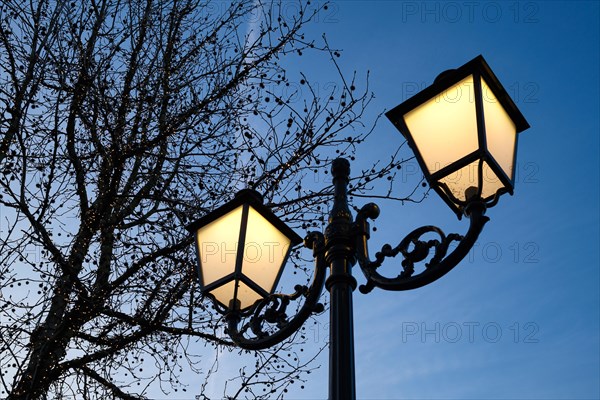 Luminous street lamp in front of a blue sky, vintage, Roermond, Netherlands