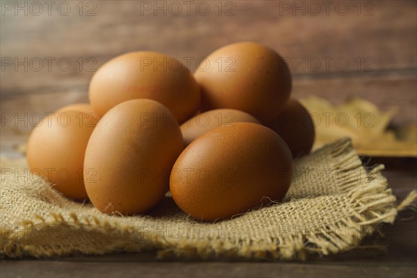 Fresh eggs on a burlap cloth on a wooden table
