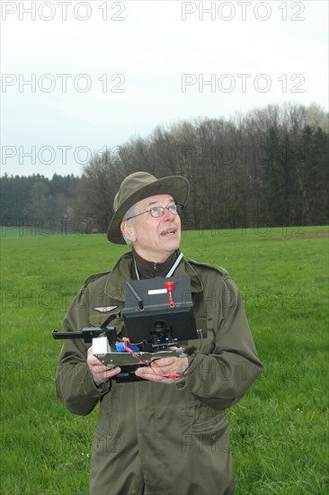 Hunter observes and controls flying drone during a hare (Lepus europaeus) census, Lower Austria, Austria, Europe