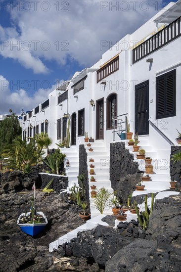 Typical white houses with small gardens on lava rock, on the promenade of Puerto del Carmen, Lanzarote, Canary Islands, Spain, Europe