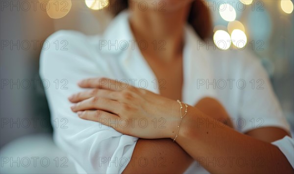 A woman in an elegant white blouse with a simple bracelet, arms folded, expressing chic simplicity AI generated