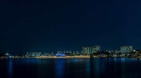 Night scene of lake side park in South Korea with city lights reflecting in the water in Sejeong, South Korea, Asia