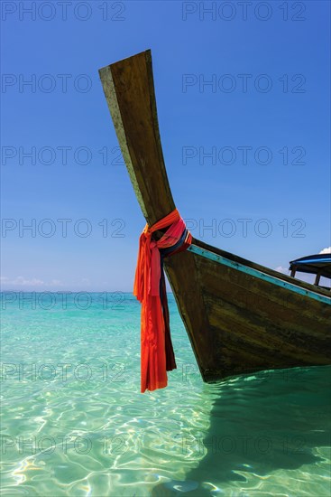 Longtail boat, fishing boat, wooden boat, decorated, tradition, traditional, faith, cloth, colourful, bay, sea, ocean, Andaman Sea, tropical, tropical, island, water, beach, beach holiday, Caribbean, environment, clear, clear, clean, peaceful, picturesque, sea level, climate, travel, tourism, paradisiacal, beach holiday, sun, sunny, holiday, dream trip, holiday paradise, paradise, coastal landscape, nature, idyllic, turquoise, Siam, exotic, travel photo, sandy beach, seascape, Phi Phi Island, Thailand, Asia