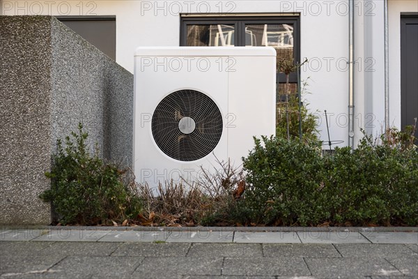 Heat pump in the front garden of a terraced house in Duesseldorf, North Rhine-Westphalia, Germany, Europe