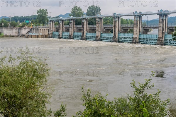 Hydroelectric dam managing rising floodwaters in a swollen river, in South Korea