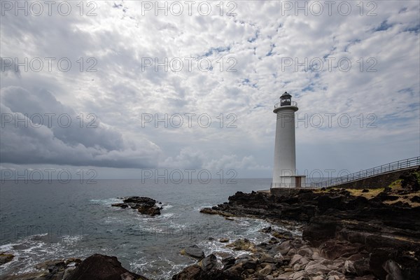 White lighthouse on a steep coast. Dramatic clouds with a view of the sea, pure Caribbean at Le Phare du Vieux-Fort, on Guadeloupe, French Antilles, France, Europe