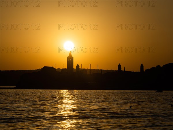 Sunset, silhouette of the church towers of Rab, town of Rab, island of Rab, Kvarner Gulf Bay, Croatia, Europe