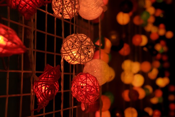Cozy atmosphere with warm, colorful interwoven sphere lights hanging together, Chiang mai, Thailand, Asia