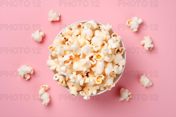 Top view of bowl with popcorn snack on pink background. KI generiert, generiert AI generated