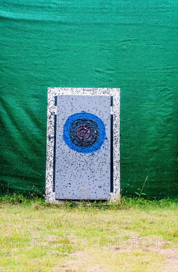 Close-up of a splattered archery target against a green tarp, in South Korea