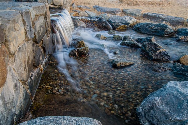 Daylight reveals the dynamic flow of a small rocky waterfall, in South Korea