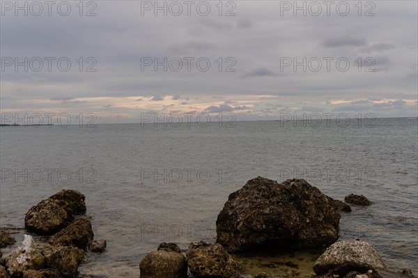Seascape of the pacific ocean with a rocky shoreline taken on a cloudy day in Guam