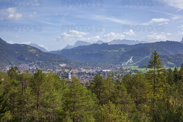 Overview of Garmisch-Partenkirchen with Karwendel mountains and forest in autumn, hiking trail Kramerplateauweg, Garmisch-Partenkirchen, Upper Bavaria, Bavaria, Germany, Europe