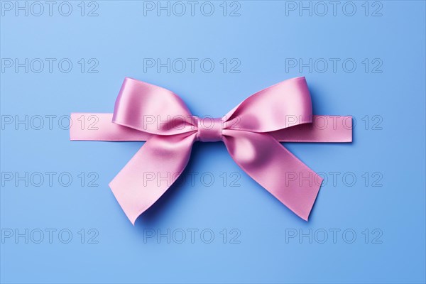 Pink tied ribbon on blue background. KI generiert, generiert AI generated