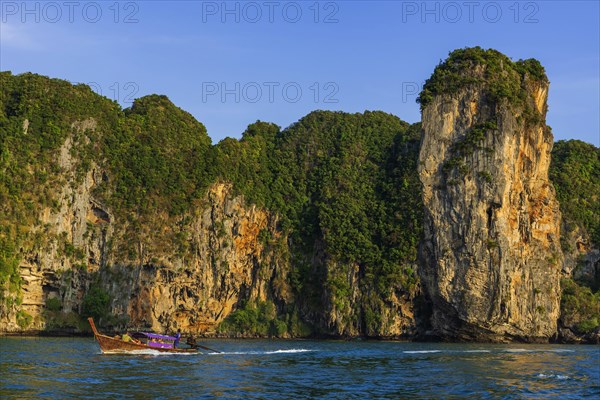 Longtail boat for transporting tourists, fishing boat, wooden boat, water taxi, taxi boat, boat, limestone rock, sea bay, bay, sea, ocean, Andaman Sea, tropical, island, water, travel, tourism, paradisiacal, sun, sunny, holiday, dream trip, holiday paradise, paradise, coastal landscape, nature, idyllic, turquoise, Siam, exotic, travel photo, Krabi, Thailand, Asia