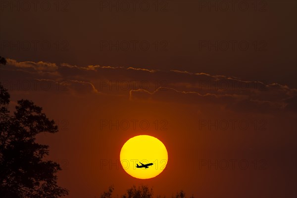 Red sun with aeroplane in silhouette, montage, evening mood, Mecklenburg-Vorpommern, Germany, Europe
