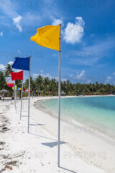 White sand beach with many flags, Bangaram island, Lakshadweep archipelago, Union territory of India