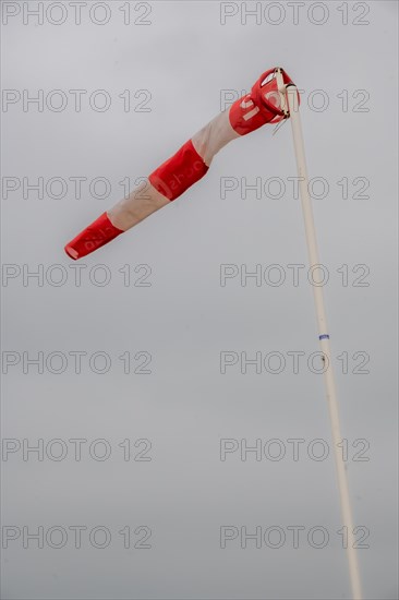 A windsock on a clear sky indicates wind direction and strength, Westkapelle, Zeeland, Netherlands
