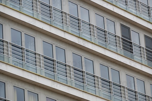 Symmetrical view of residential balconies with glass railings and white frames, Blankenberge, Flanders, Belgium, Europe