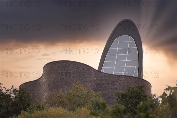 St. Mary's Church Schillig, catholic, called God's Halfpipe, church by the sea, at dusk, mystical atmosphere, green bushes and shrubs in the foreground, Schillig, Wangerland, North Sea coast, Germany, Europe