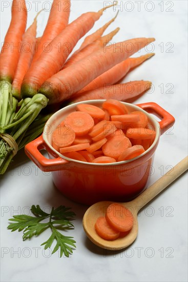 Sliced carrots in pot and bunch Carrots, Daucus carota, carrots