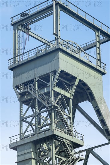 Mighty steel construction of an industrial winding tower against a blue sky, Oberhausen, North Rhine-Westphalia, Germany, Europe
