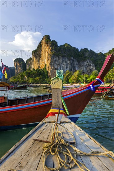 Longtail boat for transporting tourists, water taxi, taxi boat, ferry, ferry boat, fishing boat, wooden boat, boat, decorated, tradition, traditional, bay, sea, ocean, Andaman Sea, tropics, tropical, chalk cliffs, landscape, island, water, travel, tourism, paradisiacal, beach holiday, sun, sunny, holiday, dream trip, holiday paradise, paradise, coastal landscape, nature, idyllic, turquoise, Siam, exotic, travel photo, Krabi, Thailand, Asia