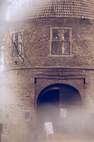 Gatehouse, moated castle, one door open, historical, formerly Bruenninghausen Castle, Rombergpark Dortmund, City of Dortmund, detail of windows and archway with displays for an exhibition, partly blurred, Dortmund, Germany, Europe