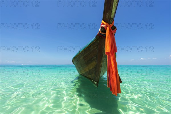 Longtail boat, fishing boat, wooden boat, decorated, tradition, traditional, faith, cloth, colourful, bay, sea, ocean, Andaman Sea, tropical, tropical, island, water, beach, beach holiday, Caribbean, environment, clear, clear, clean, peaceful, picturesque, sea level, climate, travel, tourism, paradisiacal, beach holiday, sun, sunny, holiday, dream trip, holiday paradise, paradise, coastal landscape, nature, idyllic, turquoise, Siam, exotic, travel photo, sandy beach, seascape, Phi Phi Island, Thailand, Asia