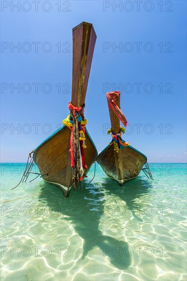 Longtail boat, fishing boat, wooden boat, boat, decorated, tradition, traditional, faith, cloth, colourful, bay, sea, ocean, Andaman Sea, tropics, tropical, island, water, beach, beach holiday, Caribbean, environment, clear, clean, peaceful, picturesque, sea level, climate, travel, tourism, paradisiacal, beach holiday, sun, sunny, holiday, dream trip, holiday paradise, paradise, coastal landscape, nature, idyllic, turquoise, Siam, exotic, travel photo, sandy beach, seascape, Phi Phi Island, Thailand, Asia