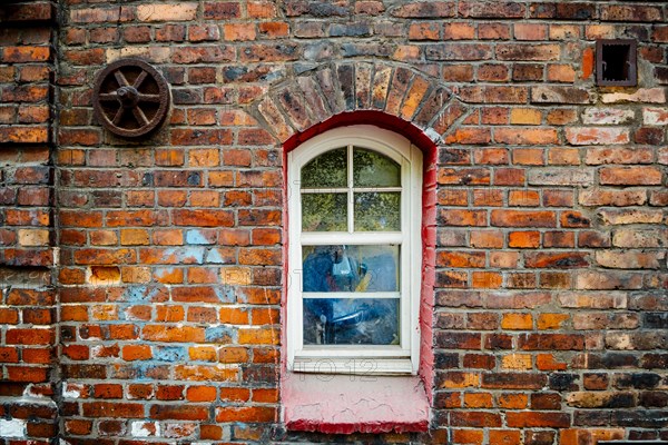 Window in brick house of Nikiszowiec, mining district of Katowice, Poland, Europe