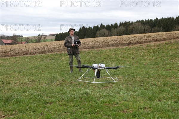 Hunter launches drone during a hare (Lepus europaeus) census, Lower Austria, Austria, Europe