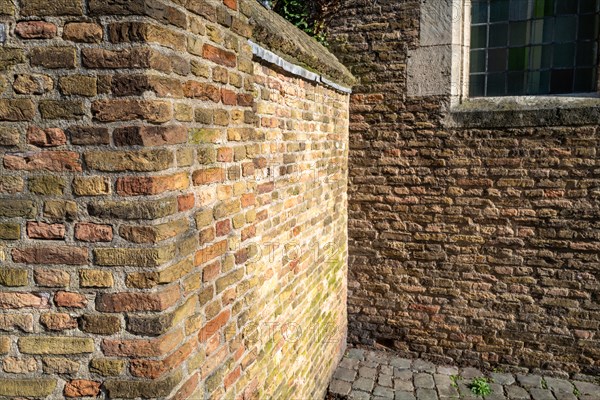 Texture-rich brick wall in the shade with clearly visible patterns