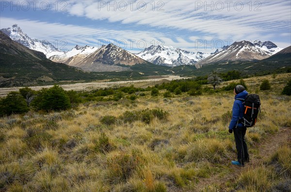 Hiker enjoying the view of the mountains and glaciers of the Patagonian Andes with Monte San Lorenzo, Perito Moreno National Park, Patagonia, Argentina, South America