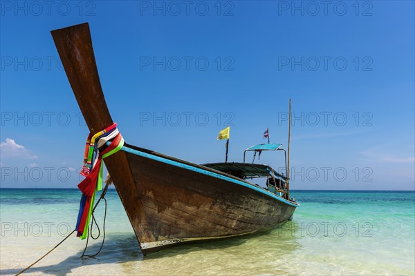 Longtail boat, fishing boat, wooden boat, boat, decorated, tradition, traditional, faith, cloth, colourful, bay, sea, ocean, Andaman Sea, tropics, tropical, island, water, beach, beach holiday, Caribbean, environment, clear, clean, peaceful, picturesque, sea level, climate, travel, tourism, paradisiacal, beach holiday, sun, sunny, holiday, dream trip, holiday paradise, paradise, coastal landscape, nature, idyllic, turquoise, Siam, exotic, travel photo, sandy beach, seascape, Phi Phi Island, Thailand, Asia