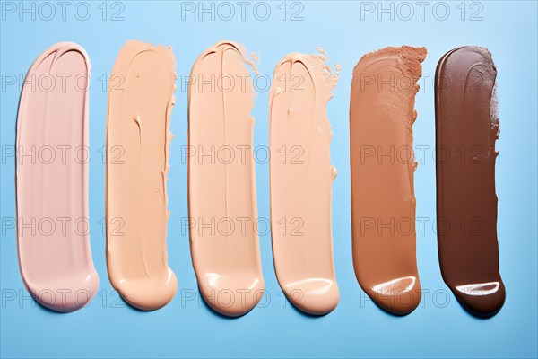 Different makeup foundation swatches for caucasian and black skin tones on blue background. KI generiert, generiert AI generated