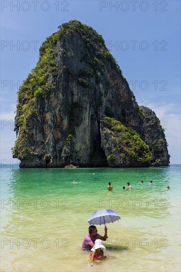 Man and child with parasol in the sun in the sea, ocean, sunshade, Andaman Sea, ozone, heat, sunstroke, sunscreen, skin cancer, protection, protect, caution, tropics, tropical, summer holiday, summer, water, beach, bathing, swimming, beach holiday, Caribbean, environment, clear, clear, clean, peaceful, climate, travel, tourism, paradise, beach holiday, sun, sunny, holiday, paradise, nature, idyllic, turquoise, exotic, travel photo, sandy beach, Thailand, Asia