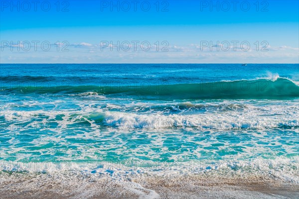 Vibrant ocean waves with rich blue tones and white surf, in South Korea