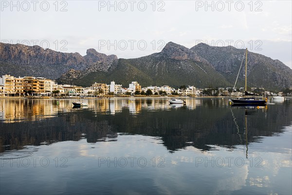 Village by the sea and mountains at sunrise, Port de Pollenca, Serra de Tramuntana, Majorca, Balearic Islands, Spain, Europe