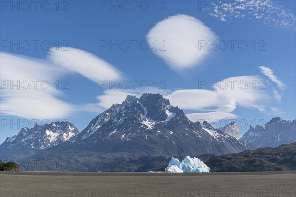 Iceberg and mountain backdrop, Lago Grey, cloud splendour, Torres del Paine National Park, Parque Nacional Torres del Paine, Cordillera del Paine, towers of the blue sky, Region de Magallanes y de la Antartica Chilena, Ultima Esperanza province, UNESCO biosphere reserve, Patagonia, end of the world, Chile, South America