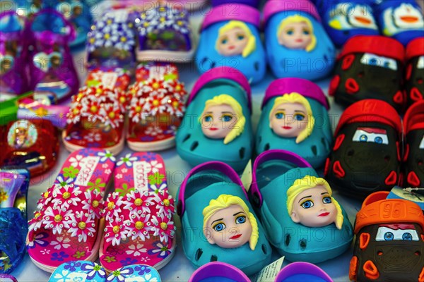 Colourful plastic children's shoes on the market, asian, colourful, funny, shoes, plastic, souvenir, flea market, bazaar, shopping, shop, Thailand, Asia