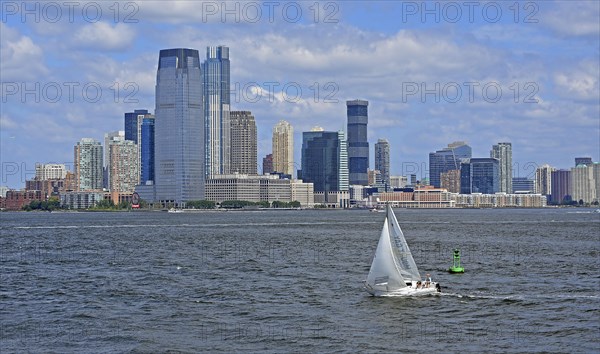 Sailboat on Hudson River in front of skyscraper skyline of Jersey City, New Jersey, USA, North America