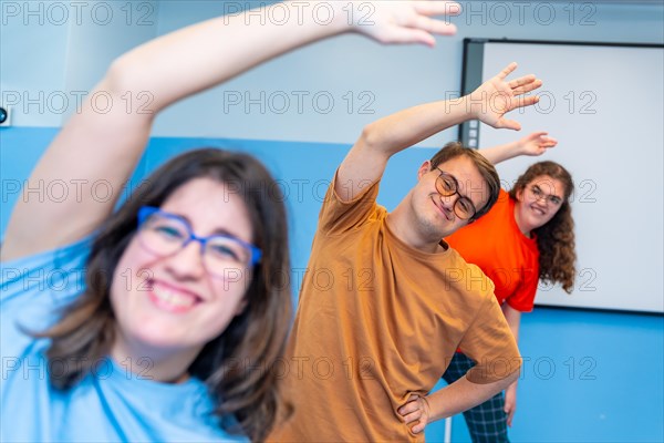 Selective focus on a man with down syndrome and friends enjoying gym class